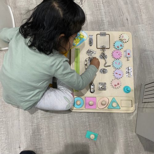 toddler playing with montessori board