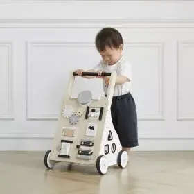 boy playing with wooden baby walker